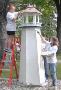 Students painting lighthouse