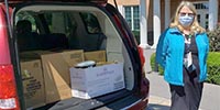 VA volunteer Barbara Abbey standing by her car